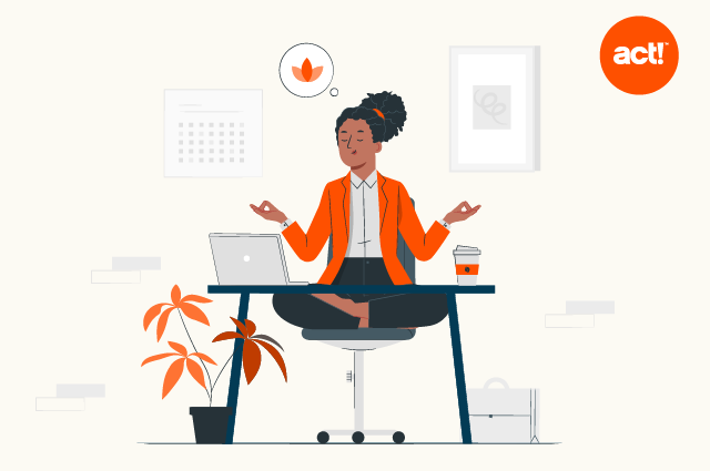 decorative illustration showing an employee sitting in a zen medatative position at her desk.