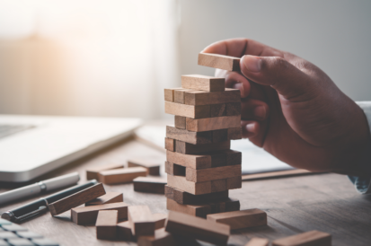 Someone playing a miniture game of jenga